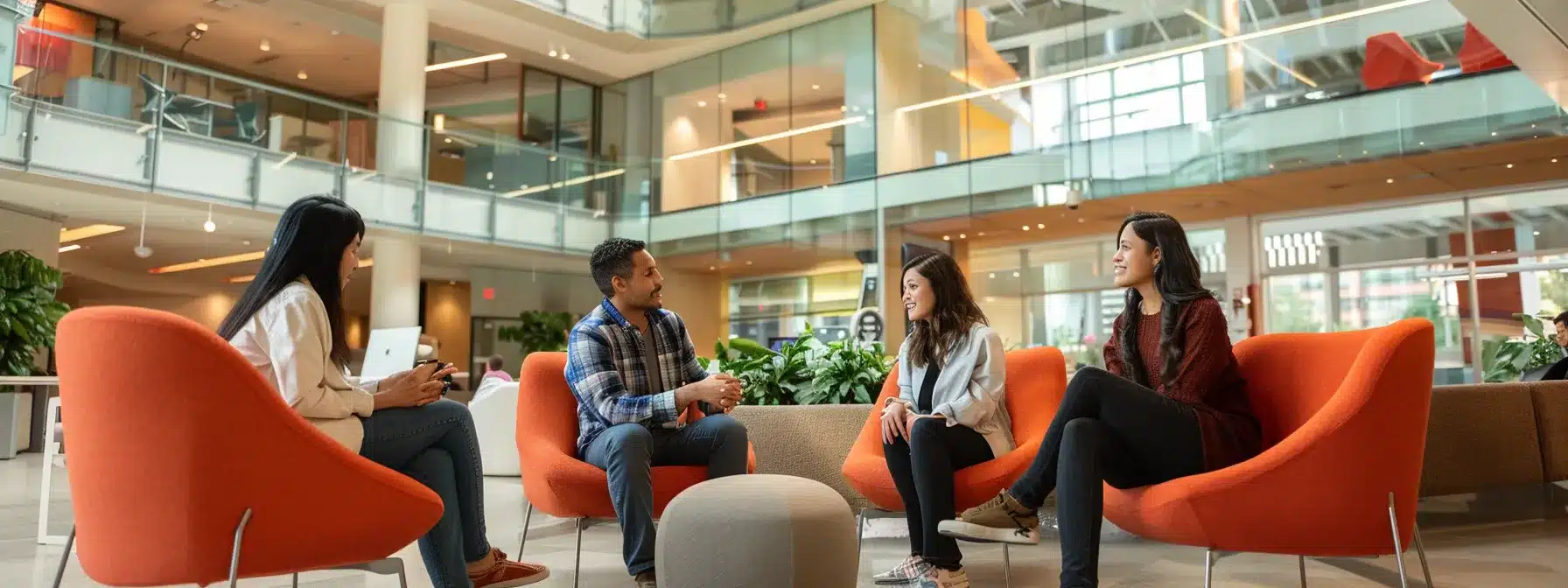 an image of diverse employees engaging in a group discussion, with a backdrop of a vibrant, welcoming office space.